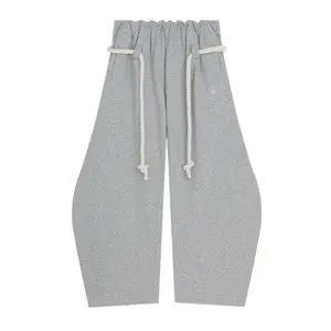 Women’s heather grey curved-leg sweatpants with thick rope drawstring, relaxed wide-leg fit, soft fabric, for daily casual wear.