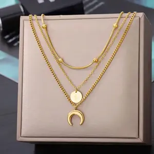 Layered Gold Tone Necklace with Heart, Crescent, and Round Pendants