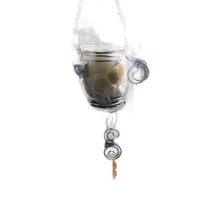 Hanging Hurricane Candle holder with sea shells, blue sea glass, crystals with orange and blue accents. Sea shells wrap around the Led candle and sits upon blue sea glass. This beautiful votive can be hung outside since it has a sturdy chain to hold it.