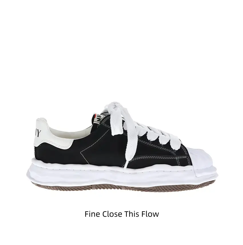 Vintage black upper shell-toe lace-up canvas sneakers with white frayed laces, wavy wrinkled white thick midsole and brown gum rubber outsole, ideal for casual office commutes and monochrome street daily outfits.