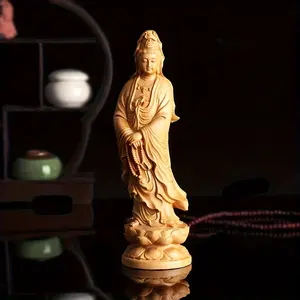A handmade wooden statue of Guanyin, an elegant and compassionate Bodhisattva, with religious decorations and a base, a spiritual art sculpture, suitable for meditation rooms and family shrines
