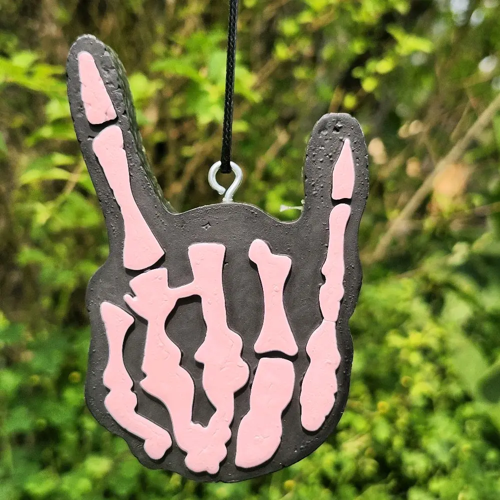 Skeleton rock hand scented car freshie. Hang from your rear view mirror.