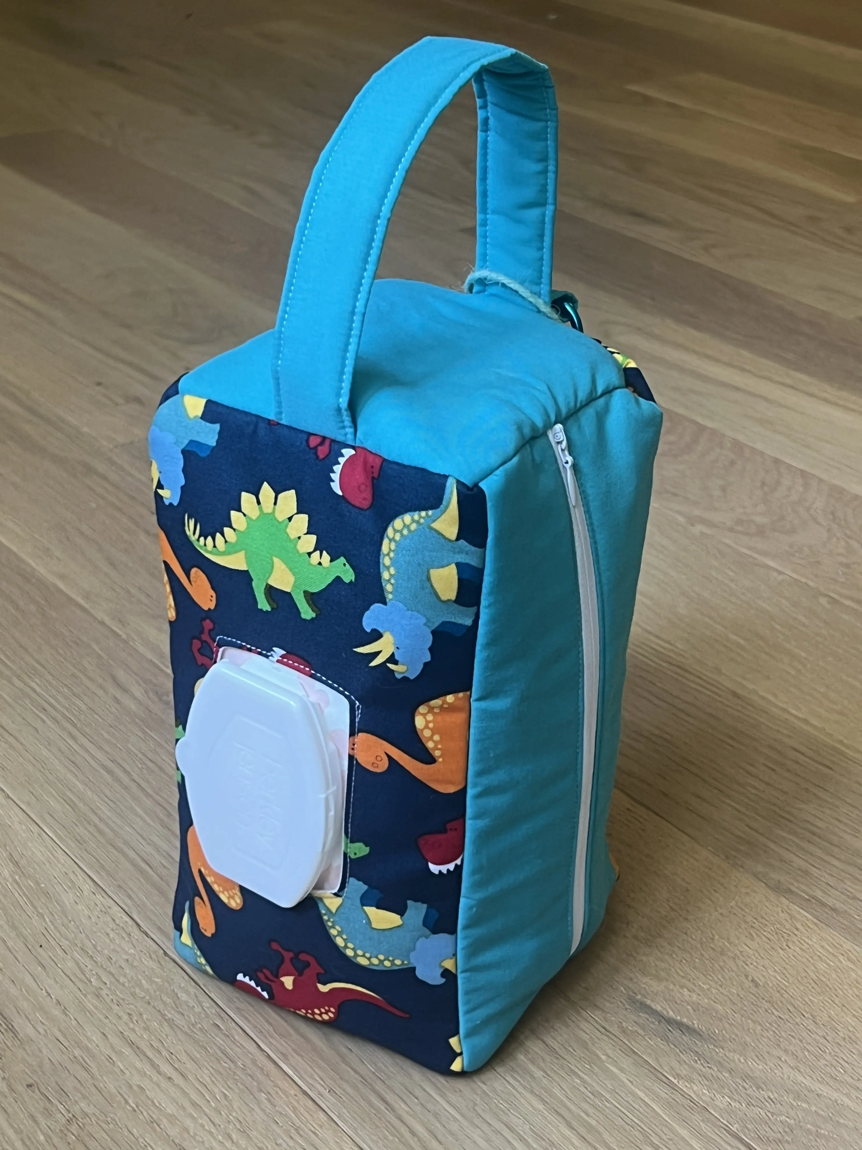 Blue Dinosaur Peanut Pouch - Baby and Toddler Essentials Bag with Handle, Wipe Hole and Keyring