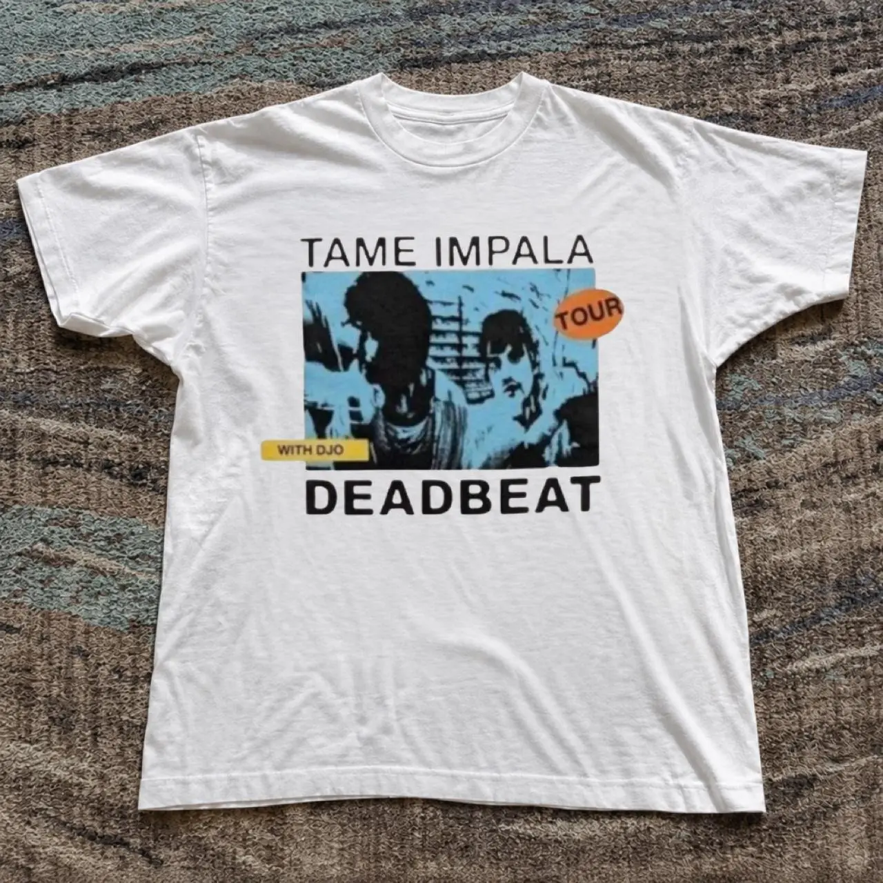 Tame Impala Deadbeat Tour Tee White cotton t-shirt with graphic of two figures with the words 'TAME IMPALA', 'DEADBEAT', and 'TOUR T-Shirt