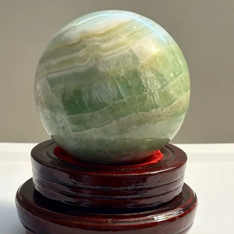 Pistachio Calcite Sphere - Natural Green & White Striped Gemstone Decorative Orb on Wooden Stand