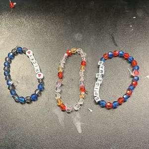 Friendship Bracelets - Colorful Beaded Designs with "O" and "S" Letters, Featuring Red and Blue Beads