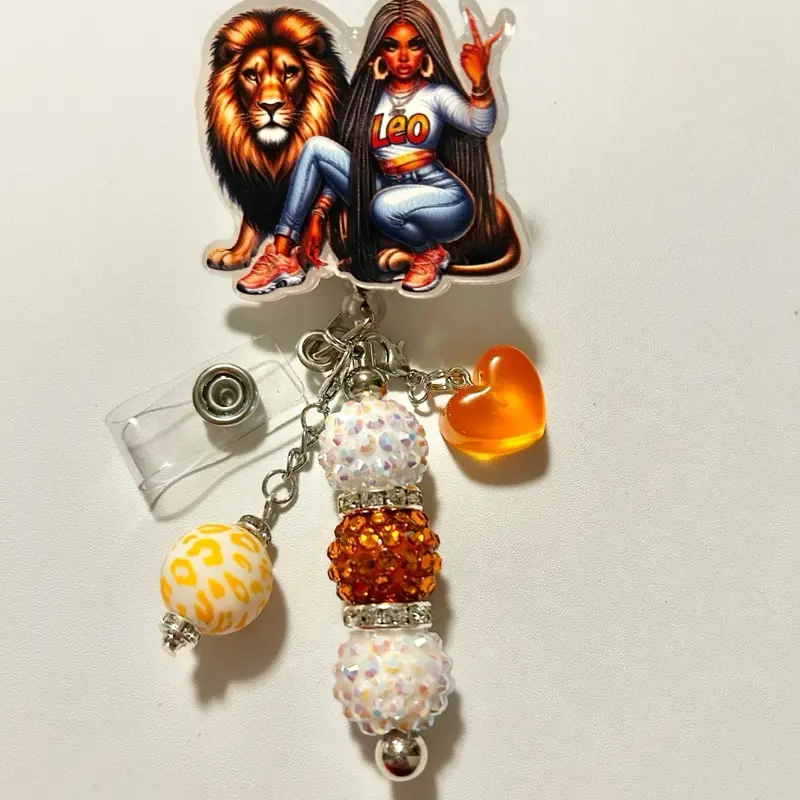 Charmed- Cute trendy retractable badge reel with alligator clip and colorful beads. Charms may vary from photo but will match colors in acrylic piece.