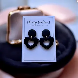 Handmade polymer clay black heart dangles.