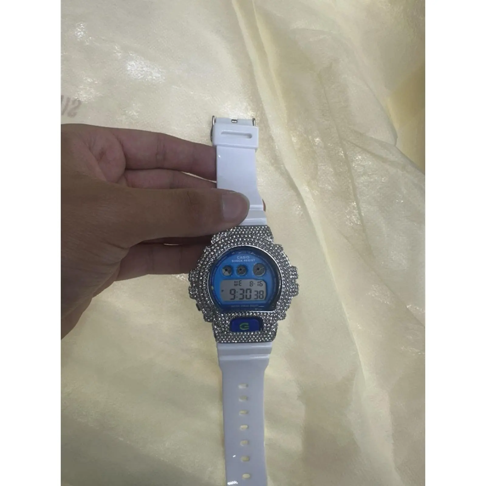 Iced Out White Watch with Silver-Tone Bezel, Blue Dial, and Adjustable Buckle Closure