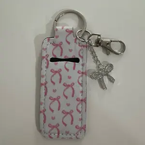 Lip Gloss Keychain with Pink Bow Pattern and Silver Charm Accessory