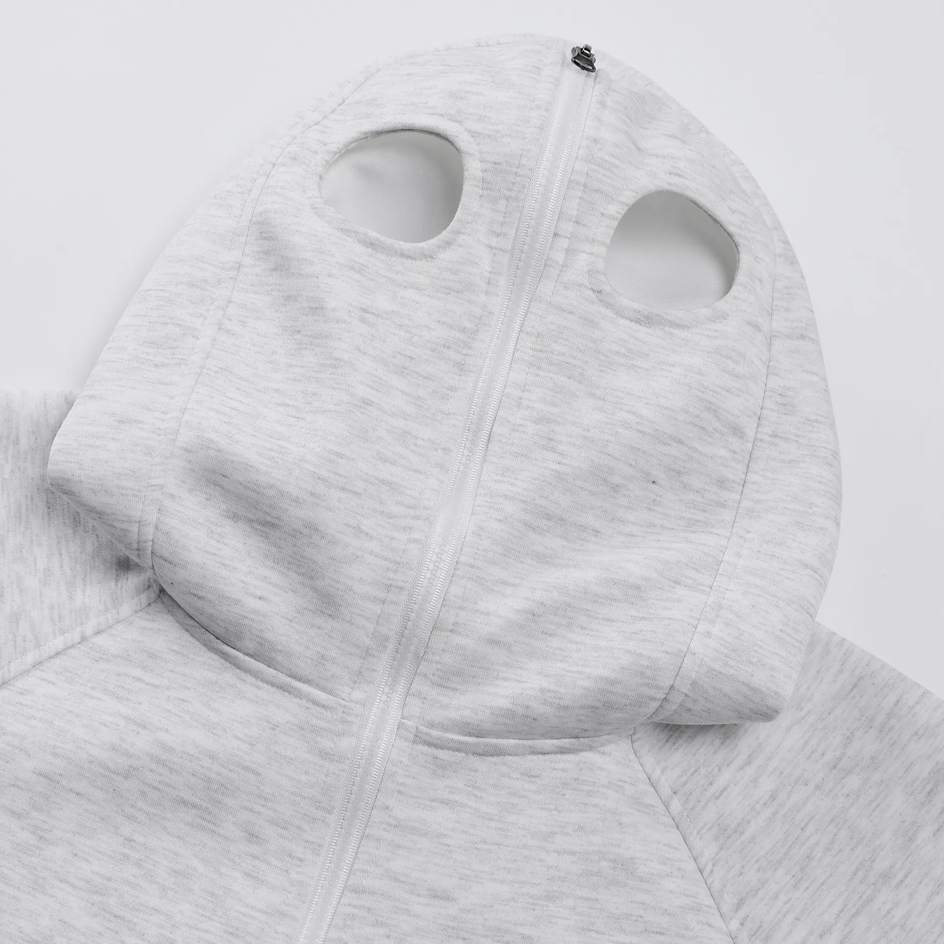 A men's zip up hoodie with a unique eye hole cutout design