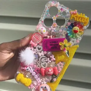 iPhone Junk Case - Colorful Design with Various Decorative Elements and "Kitty" Text, Featuring Butterfly and Heart Shapes