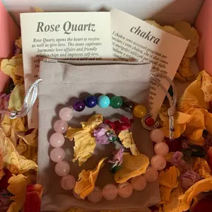 Rose Quartz Bracelet with Chakra Information Card - Pink Beaded Bracelet Displayed on dried Rose Petals