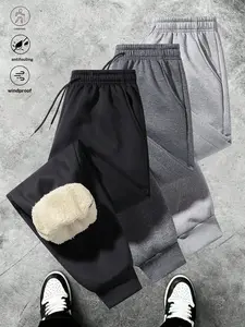 Three stripe athletic jogger pants, featuring a minimalist style with a drawstring waistband, practical aesthetic, ankle cuffs for a clean finish, and inner fleece for soft comfort. Suitable for daily commuting and outdoor strolls, these pants offer versa