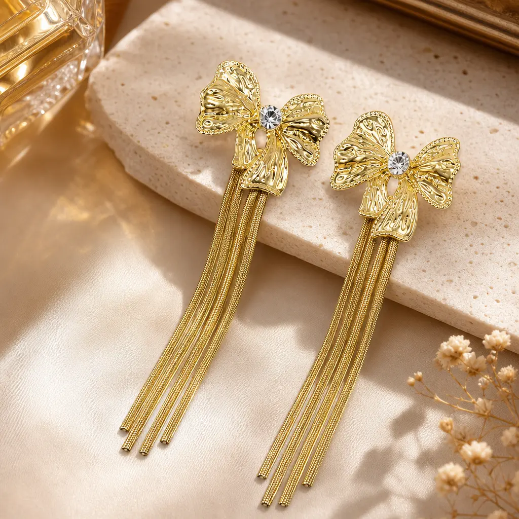 Gold-Tone Sculpted Ribbon Bow Tassel Drop Earrings with Clear Decorative Accent for Women
