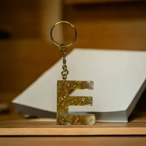 E Resin alphabet keychain with gold flakes  and purple stones
