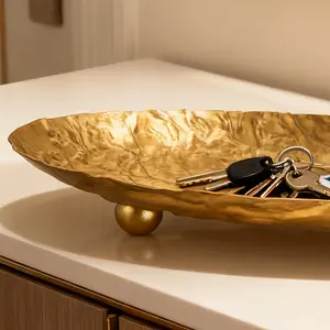 Handmade iron art storage tray with golden hammered texture, three-legged stable support, an elegant integration of home decoration and practical storage