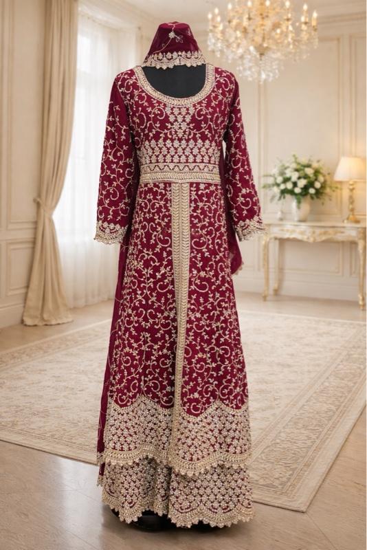 This image shows a green designer heavy embroidered bridal lehenga or Anarkali suit suited for traditional Indian weddings. Womenswear