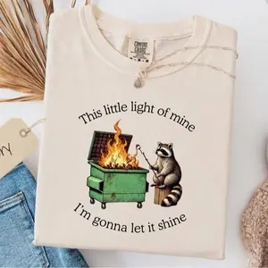 Comfort Colors funny parody shirt featuring a dumpster fire raccoon graphic, blending humor and sarcasm into a relaxed, comfortable mental health tee for everyday wear.