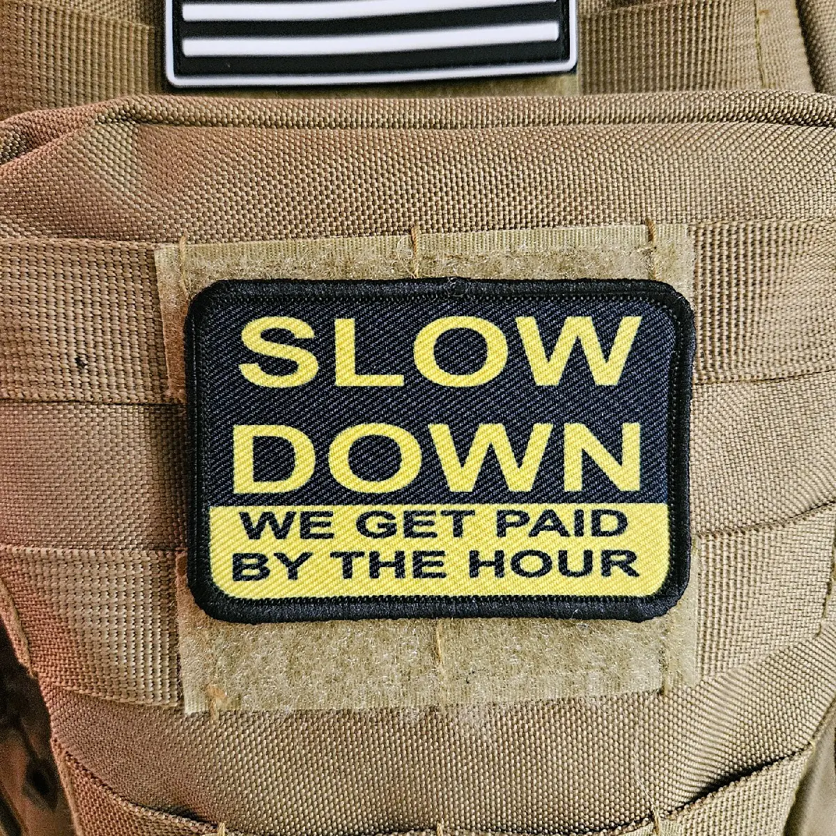 slow down we get paid by the hour patch 2"x3" removable morale patch with hook and loop backing blue collar