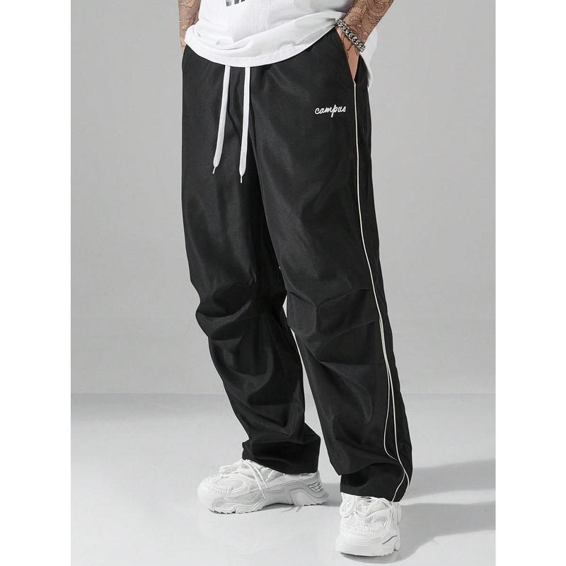 Loose-fitting sweatpants for men, grey side stripes with gold accent stripes, comfortable design, sports casual style bottoms, sweatpants, fitness wear, today's fashion outfit
