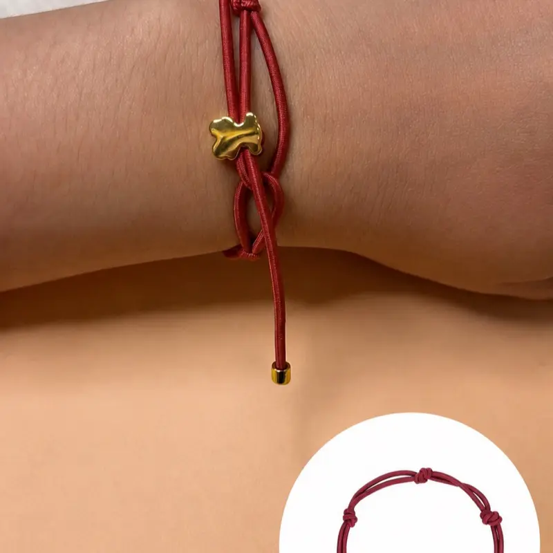 Elegant adjustable red cord bracelet featuring a polished gold-tone charm. Lightweight, comfortable, and perfect for everyday wear. Its minimalist design pairs easily with any outfit and makes a thoughtful gift for birthdays, anniversaries, holidays, or s