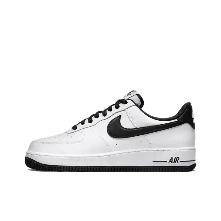 White leather black swoosh vintage brushstroke Air Force 1 low sneakers, classic unisex hypebeast street kicks, thick black round laces, faded smudge print on rubber midsole, smooth full-grain leather upper, layered stitched toe box, textured traction