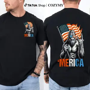 _Bigfoot ’Merica T-Shirt – Funny Patriotic Tee Featuring Sasquatch Holding Flag & Throwing a Hand Gesture, Lighthearted American Pride Shirt for Men & Women