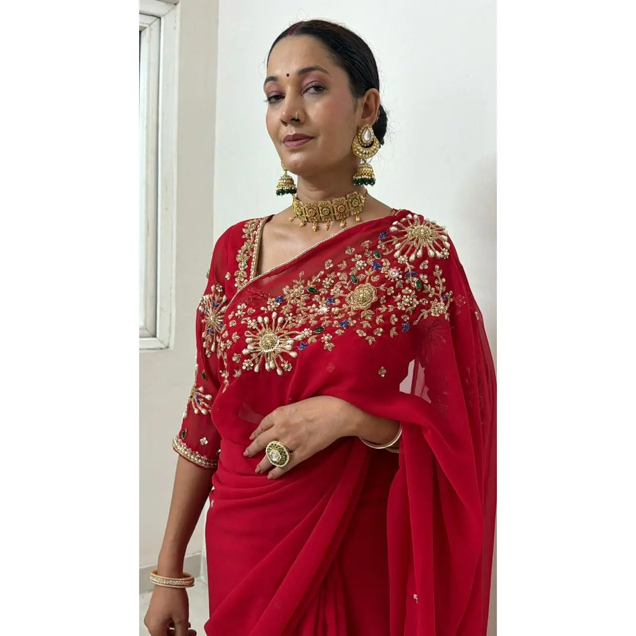 Red Saree with heavy hand work of sequins, pearls, cutdana, dabka work and green stonework