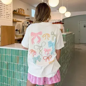 Colorful Pastel Bows Graphic Tee Aesthetic Coquette Style White T-shirt with Ribbon Design Soft Breathable Loose Fit Short Sleeve Top for Women Daily Wear Summer Vacation Party Gift for Her Cute Fashion Statement Piece Comfortable Trendy Clothing