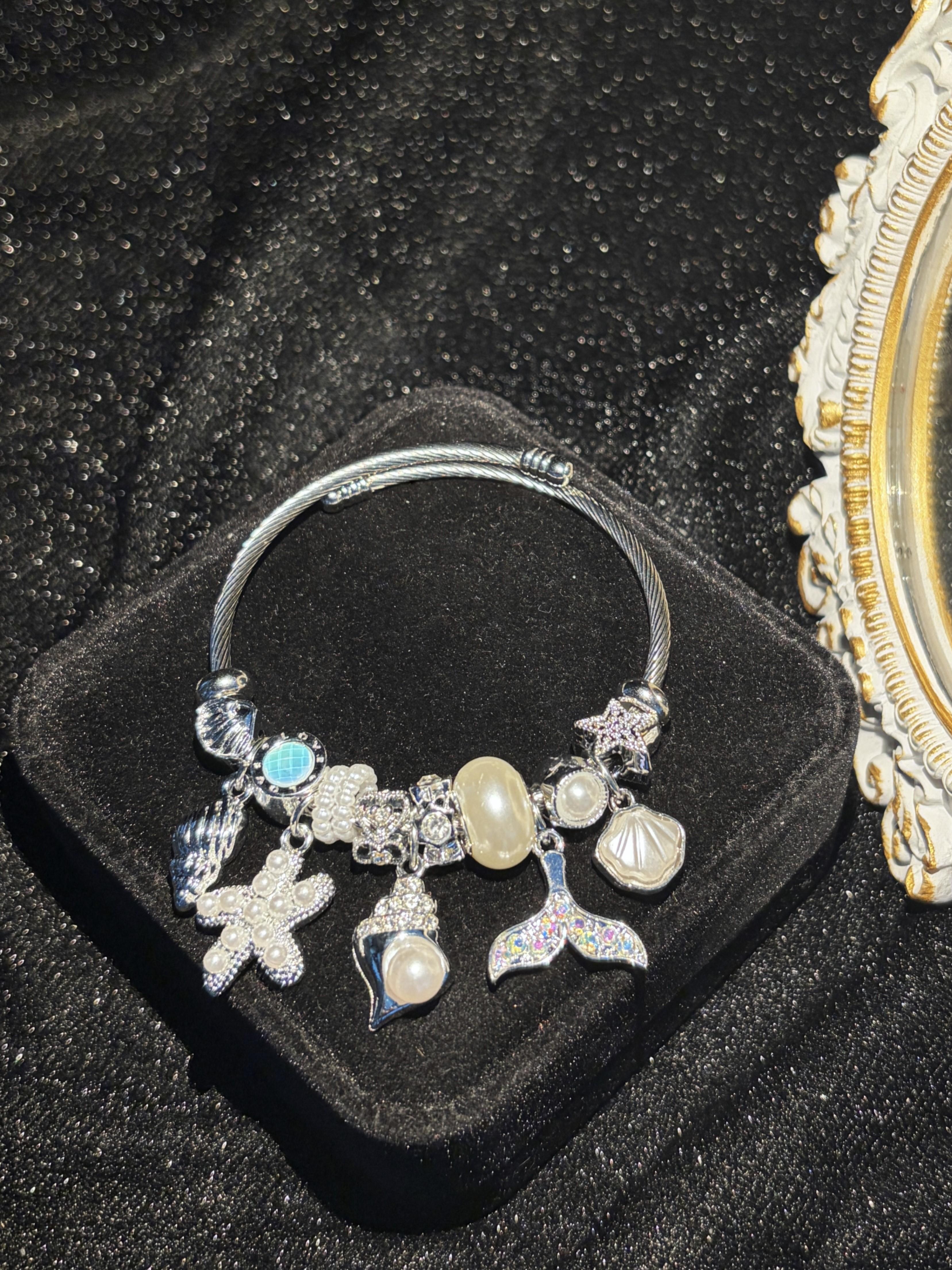 Silver-Tone Open Twist Wire Cuff Bangle, Sparkly Ocean Theme Charm Bracelet with Mermaid Tail, Starfish, Shell, Pearl Charms, Stackable Summer Holiday Costume Jewelry for Gifting Silver-Tone Open Twist Wire Cuff Bangle, Sparkly Ocean Theme Charm Bracelet with Mermaid Tail, Starfish, Shell, Pearl Charms, Stackable Summer Holiday Costume Jewelry for Gifting