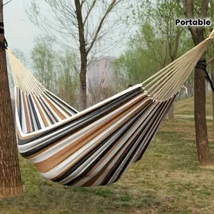 Brown fabric hammock, designed specifically for single use, features anti roll design - supports up to 330 pounds, comes with straps and a portable storage bag - suitable for outdoor, indoor, and camping use, making it an ideal choice for travel