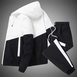 Men's two-piece set includes a zippered hoodie with drawstring and colorblock design, along with sweatpants featuring an elastic waistband. Regular fit casual long-sleeve jacket and pants are suitable for autumn and winter, perfect for everyday wear.