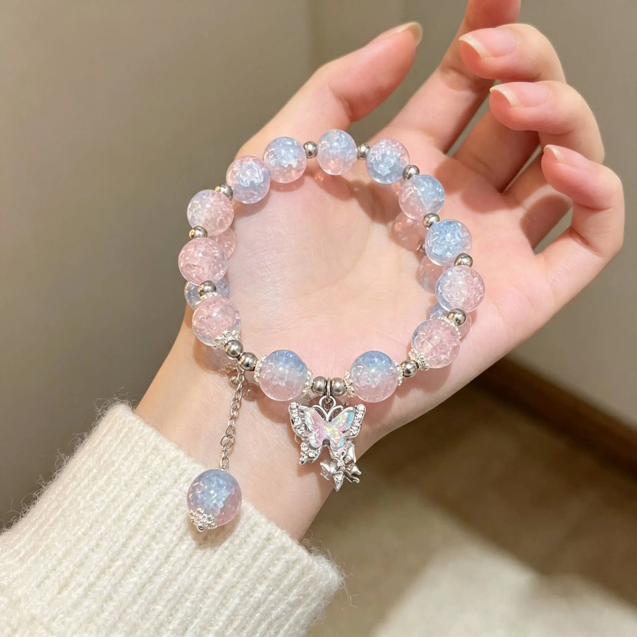 Pink-and-blue gradient beaded bracelet with butterfly pendant made of glass beads