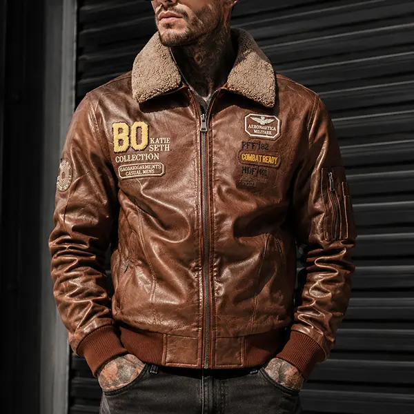 Men's fleece-lined aviator leather jacket with intricate embroidery patches and a vintage distressed brown finish