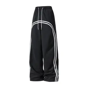 Black wide band drawstring sports casual pants, showcasing street fashion appeal, with an adjustable drawstring waistband to fit various waist sizes, featuring a unique white linear pattern design, adding visual interest to the pants, suitable for young p