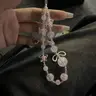 ins style sweet and cool light luxury girl pink flower burst beads alloy bow tie mobile phone chain phone case accessory Stylish Phone Accessories ccd camera chain bead string Phone Strap Phone Charms