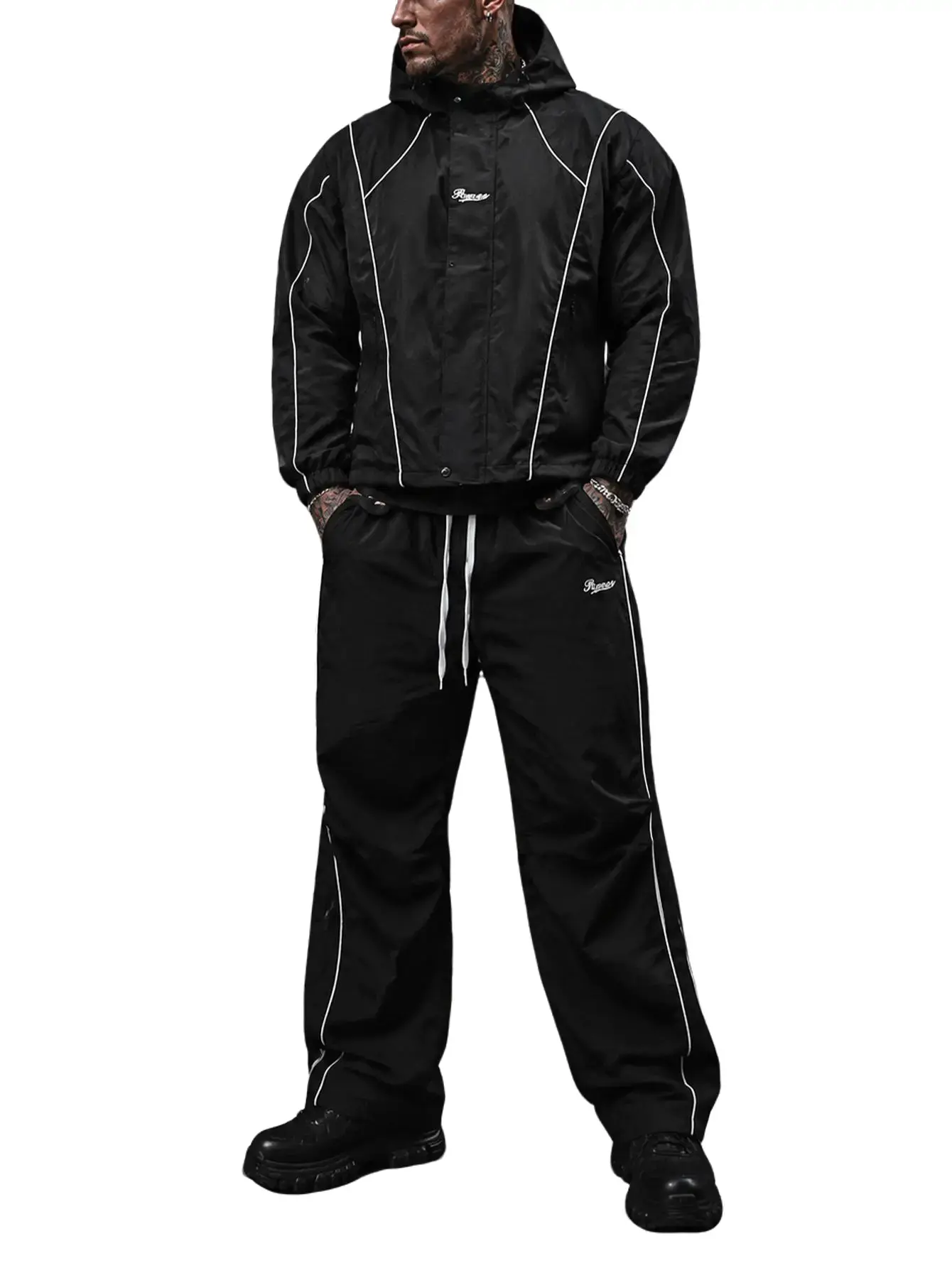 Men’s black high‑street two‑piece athletic set with visible reflective stripes and embroidered lettering, featuring a short windproof jacket and wide‑leg straight‑leg pants.