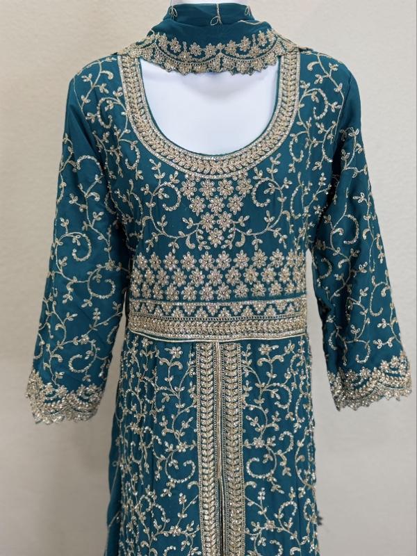 This image shows a green designer heavy embroidered bridal lehenga or Anarkali suit suited for traditional Indian weddings. Womenswear