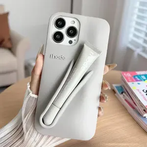 This fashionable, multi-colored silicone phone case features a built-in lip balm holder, a durable protective shell, a cute minimalist design, and is a portable beauty accessory for women and girls.