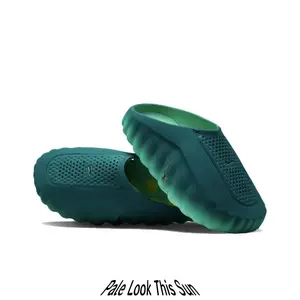 Streetwear casual slides featuring smooth molded foam upper, rich dark teal contrasted by soft pale yellow circular outsole grips, wavy rugged silhouette that elevates every earthy-toned summer street outfit