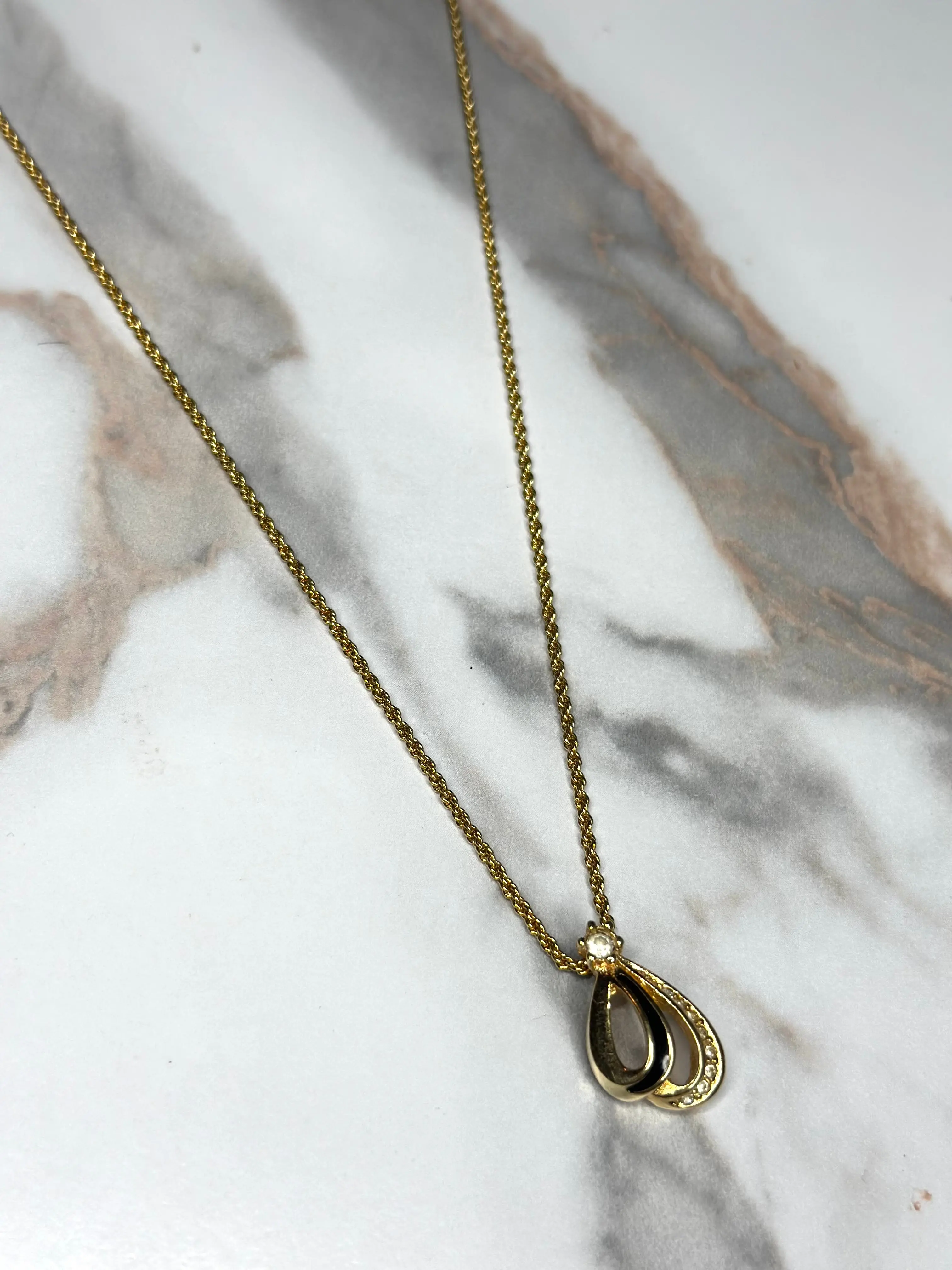 Pre-owned Christian Dior vintage necklace features a gold tone teardrop pendant set with black enamel and crystals