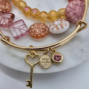 Pink and gold bangle bracelet stack.