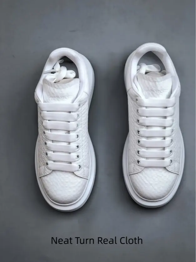 Clean embossed white platform casual shoes. Full textured leather construction, minimalist monochrome design. Elevate your neutral tone outfits effortlessly.
