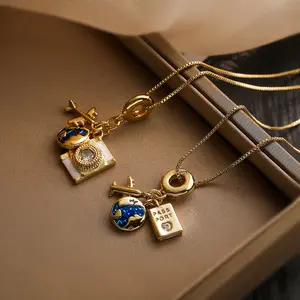 Golden Travel-Themed Pendant Necklaces - Enamel Airplane, Globe & Passport Charms, Fashionable Travel-Inspired Jewelry for Wanderlust Enthusiasts