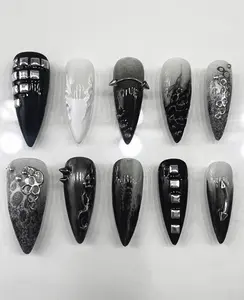 Edgy black and grey ombre nails with chrome studs, spikes, abstract molten textures, and grunge metallic detailing—perfect cyber-goth statement claws