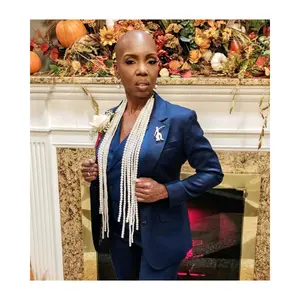Power Tie for Women Stylish Blue Suit with Pearl Necklace and Brooch Perfect for Formal Events and Professional Settings Versatile Design Bold Statement Empowering