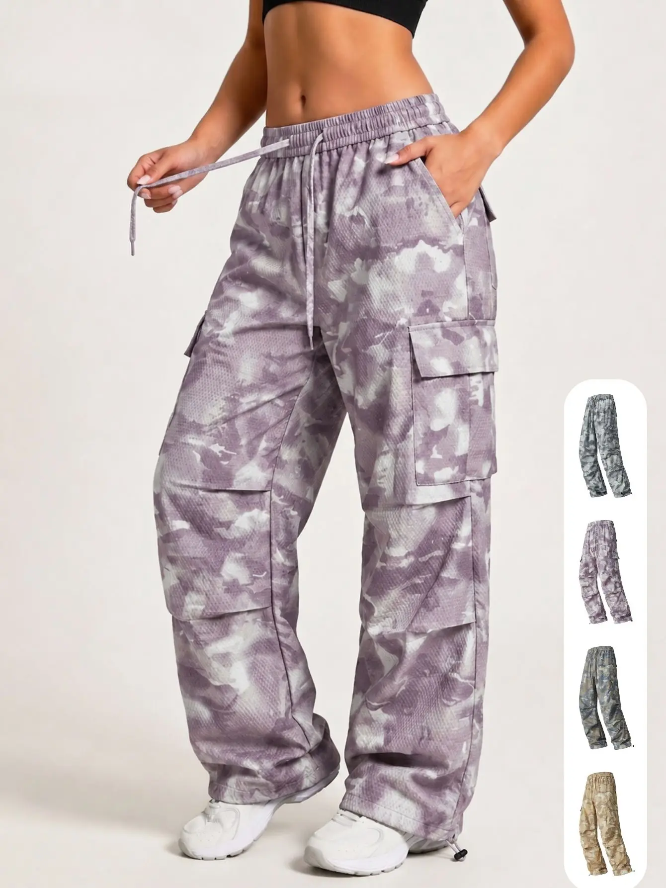Women's casual wide-leg cargo pants in a light purple camouflage print, featuring large side pockets, a drawstring waist, and cuffed ankles.
