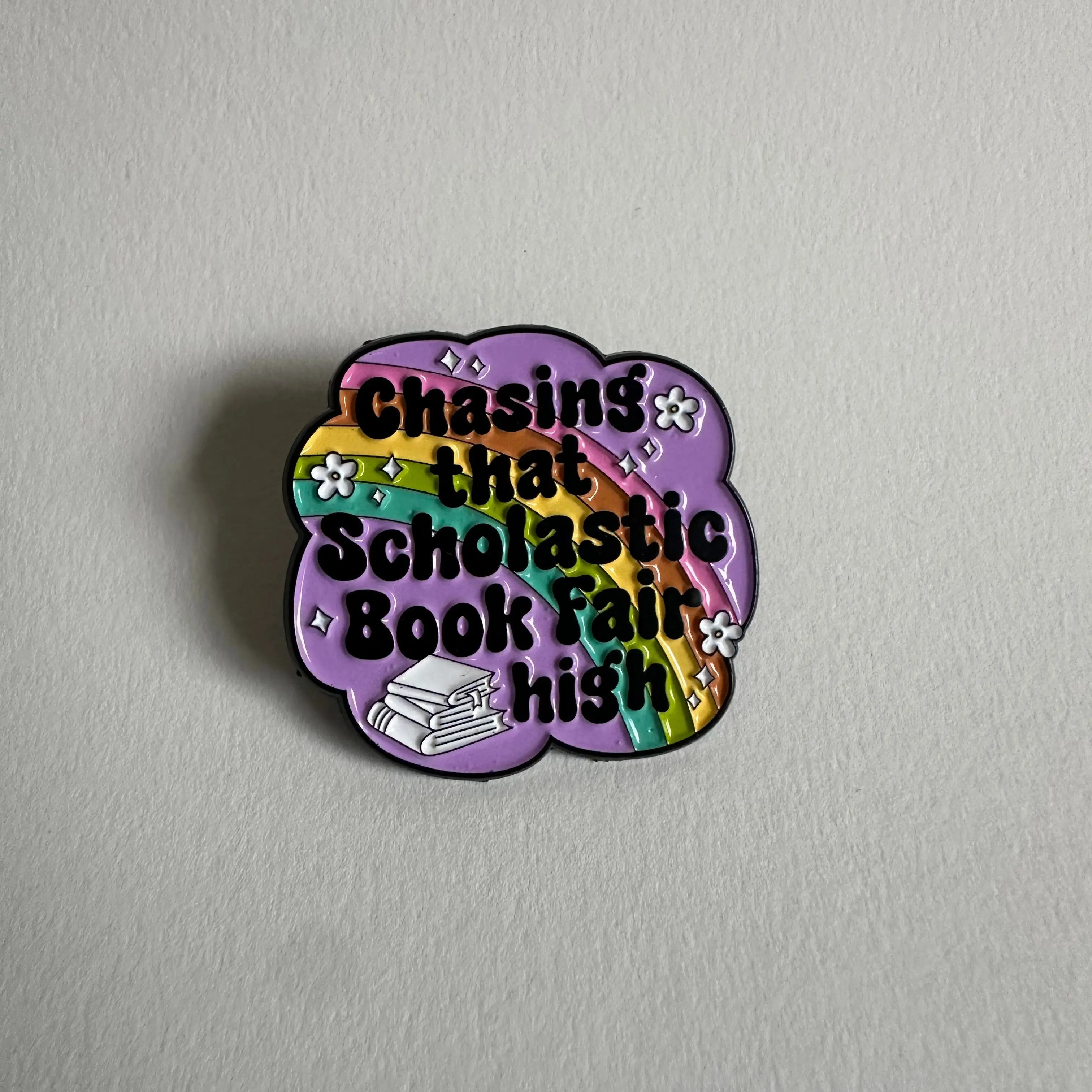 Chasing That Scholastic Book Fair High Enamel Pin, 1.3” x 1.3”