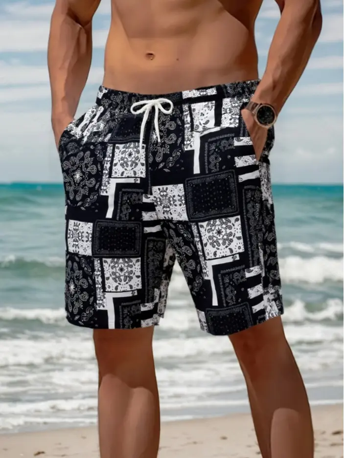 Men’s casual shorts featuring a black and white nut motif patchwork print; urban relaxed style with a retro, eye‑catching black and white nut motif as the main color. Elastic waistband with drawstring, paired with an all‑over nut motif patchwork print. Li